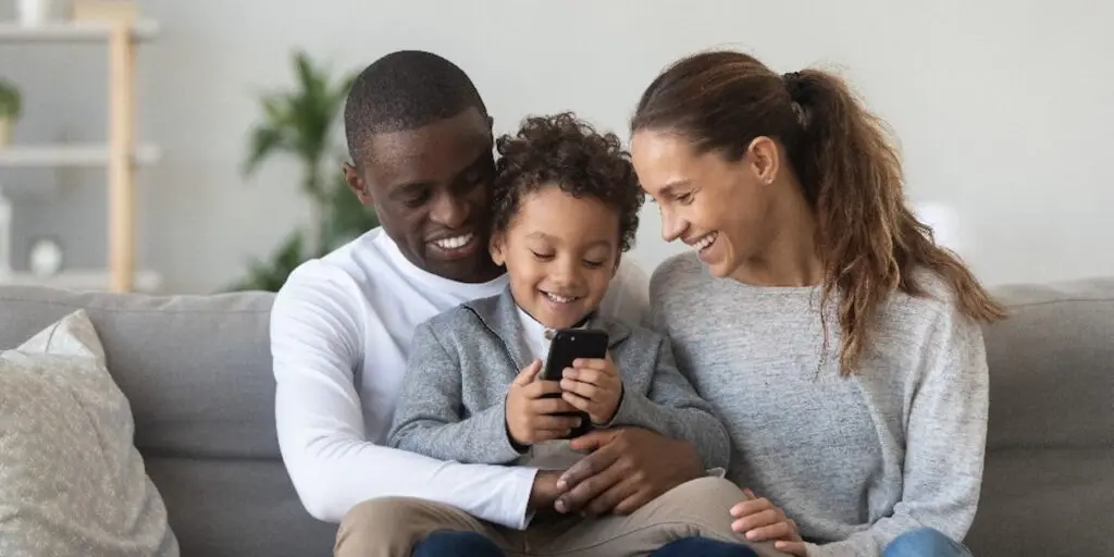 A man and a woman holding a child.