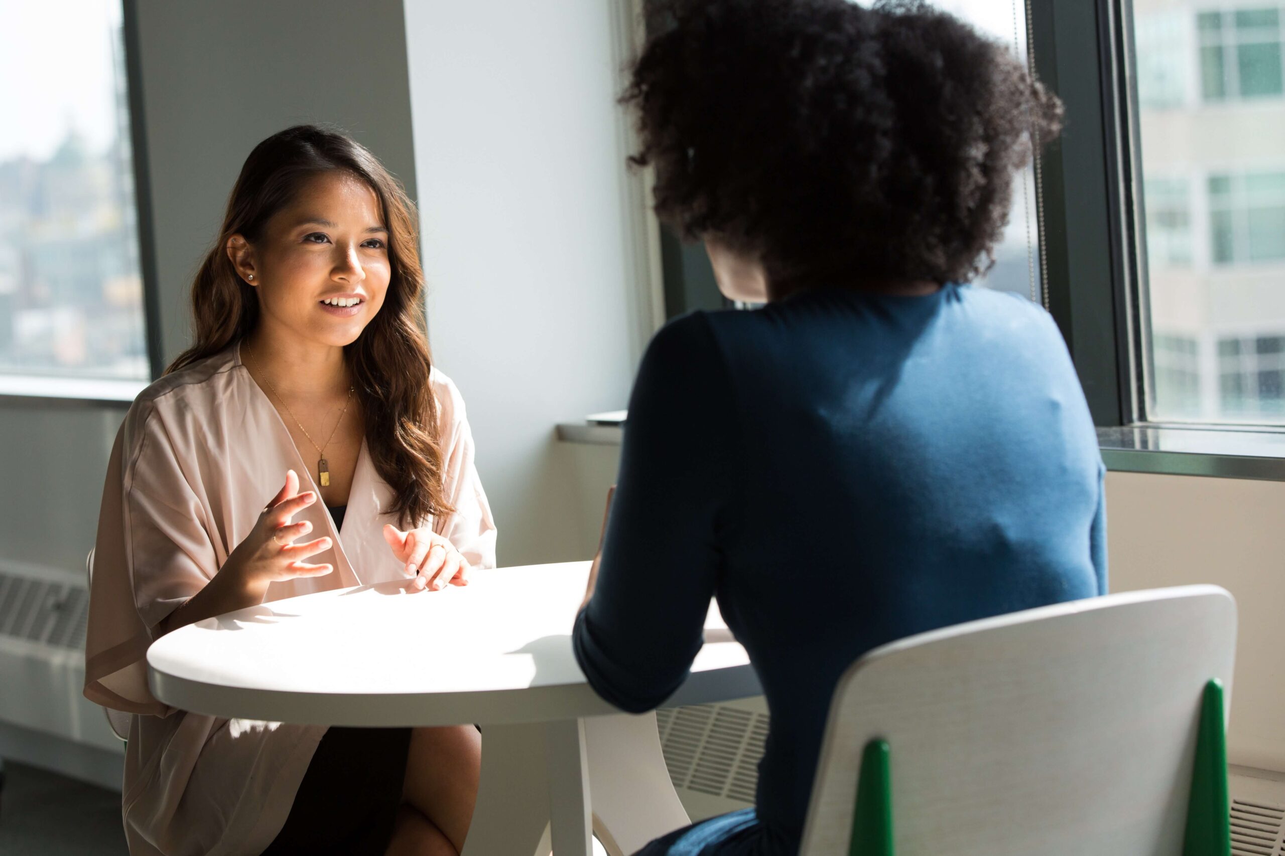 Two women discussing how to speed up clinical trials