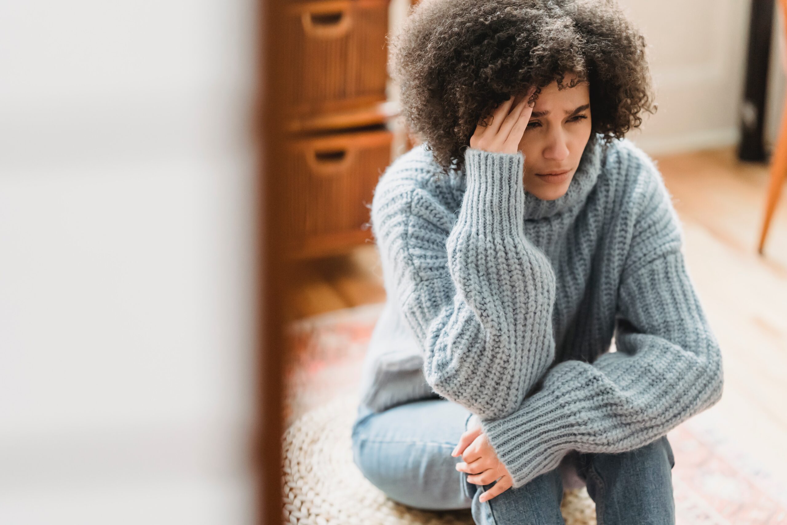 Young migraine patient holding head in pain